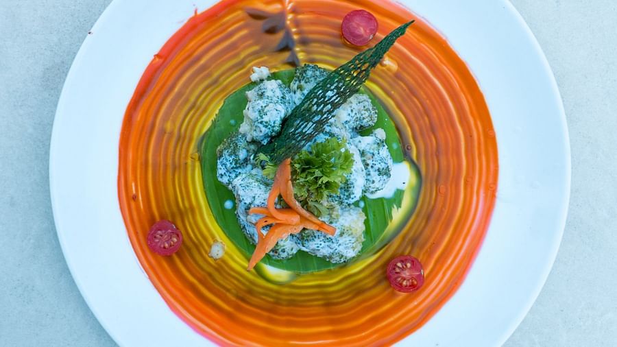 A plate with a circular arrangement of sauces and a central garnish.