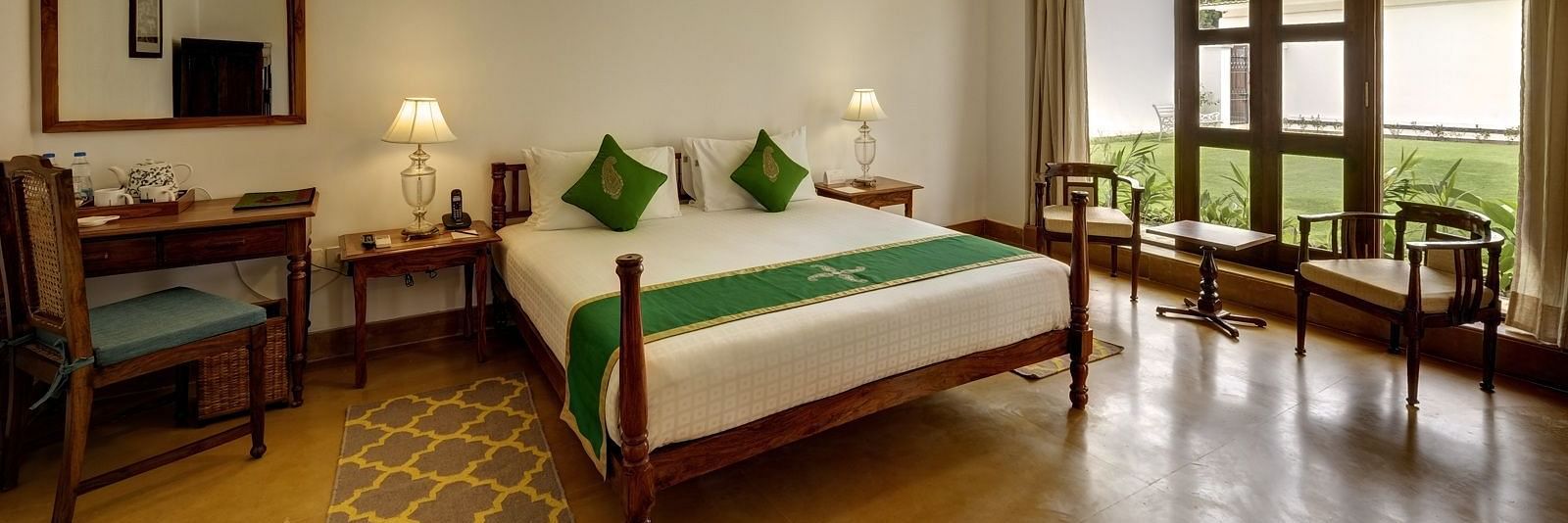 Residency Room with a double bed and a work desk and chair at Saraca Hotel, Lucknow