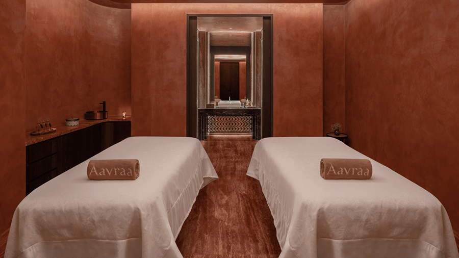 Spa treatment room with two massage beds set against warm toned walls at The Residency Signature Madurai.