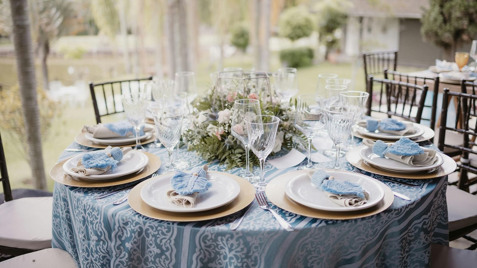 A beautifully arranged table and chairs, adorned for an event.