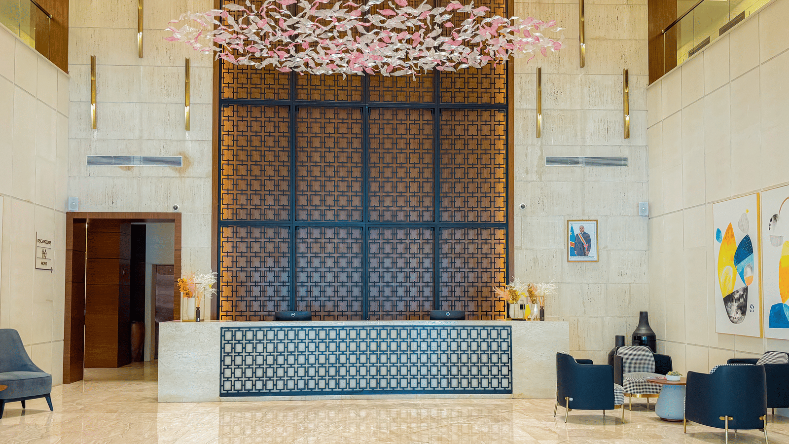 Spacious lobby at KertelSuites, featuring a stylish and elegant chandelier hanging overhead
