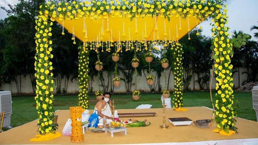 Close-up of a ceremonial mandap decorated with vibrant yellow flowers and hanging elements at Ilara Hotels & Spa, OMR, Chennai