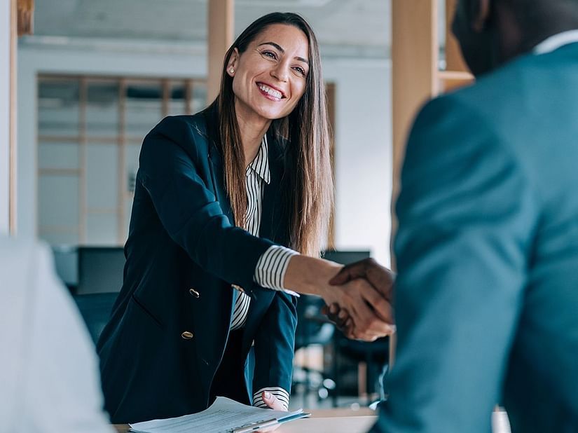 A handshake between a woman and a man in a meeting setup - S Hotel Kingston, Jamaica