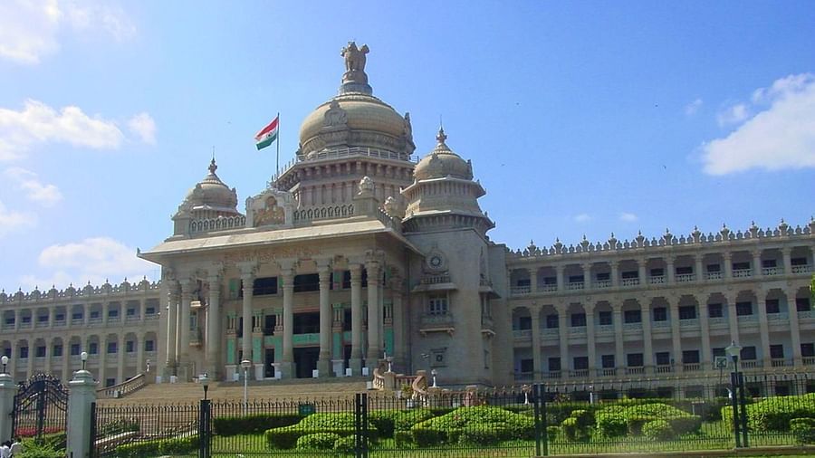 the building of Vidhana Soudha decked in white exterior with a garden laid in front of it