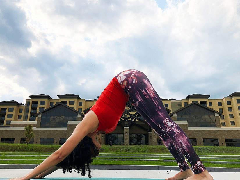 woman doing yoga on a mat outdoor