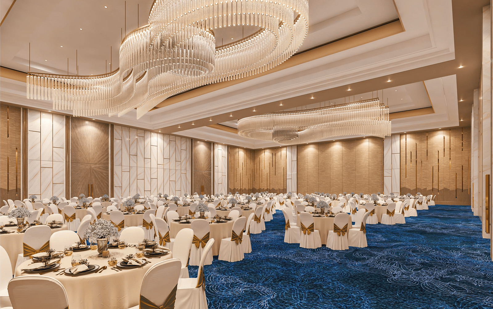 A banquet seating arrangement with chandeliers, an elegant carpet and modern interior at Merlis Hotel, Coimbatore