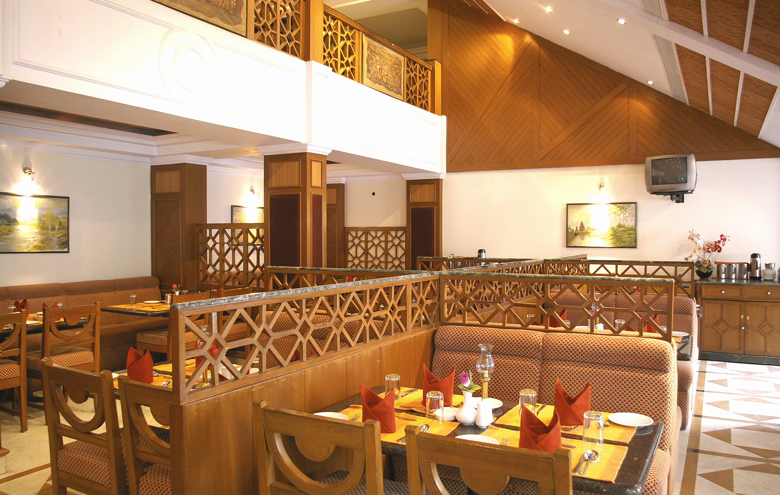 A dining seating of a restaurant at Regency Kanchipuram by GRT Hotels.