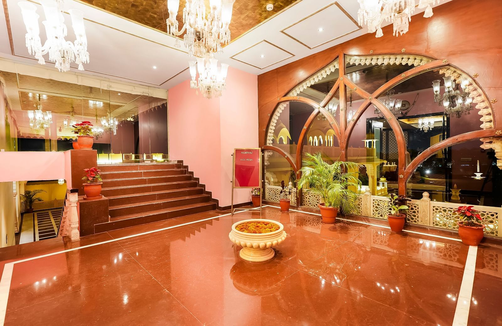 An overview of the lobby of Rajasthali Resort & Spa, Jaipur with many chandeliers seen