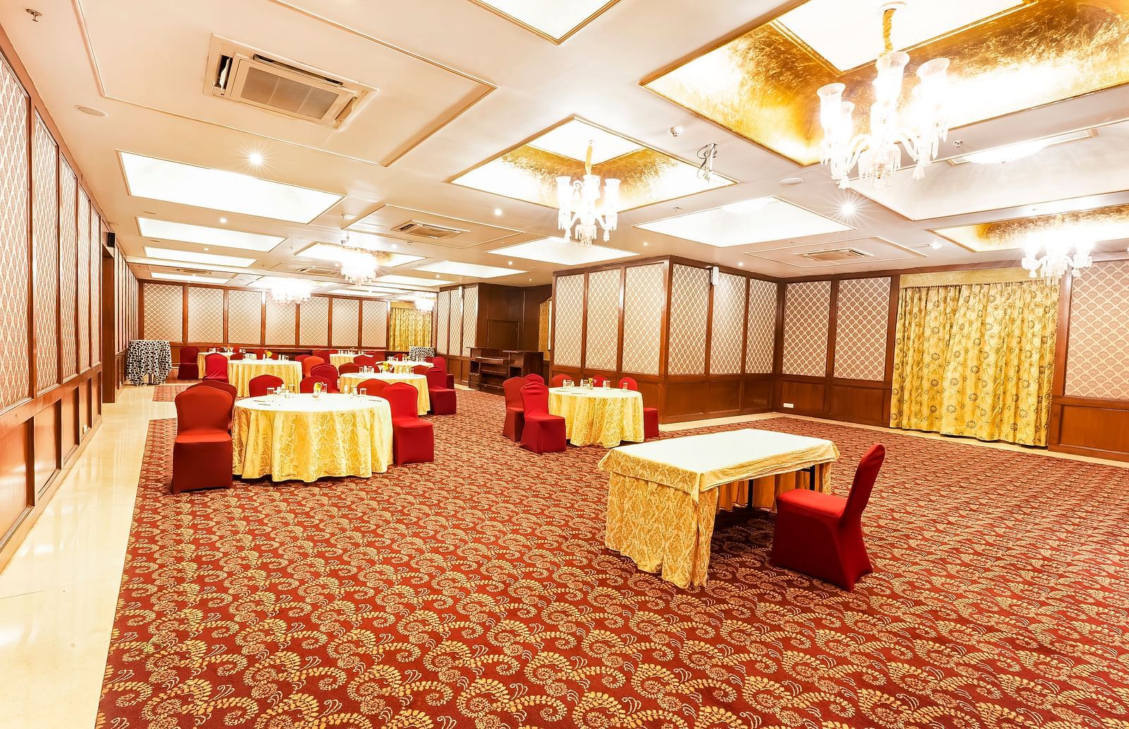 An overview of the banquet hall with round table seating inside - Rajasthali Resort & Spa, Jaipur