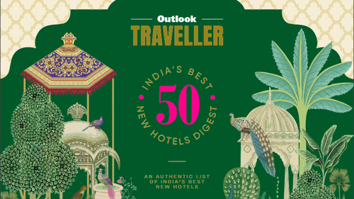 Cover page of Outlook Traveller magazine featuring a design inspired by the Mughal era, with a palm tree, swimming pool, and flowers floating on the water.