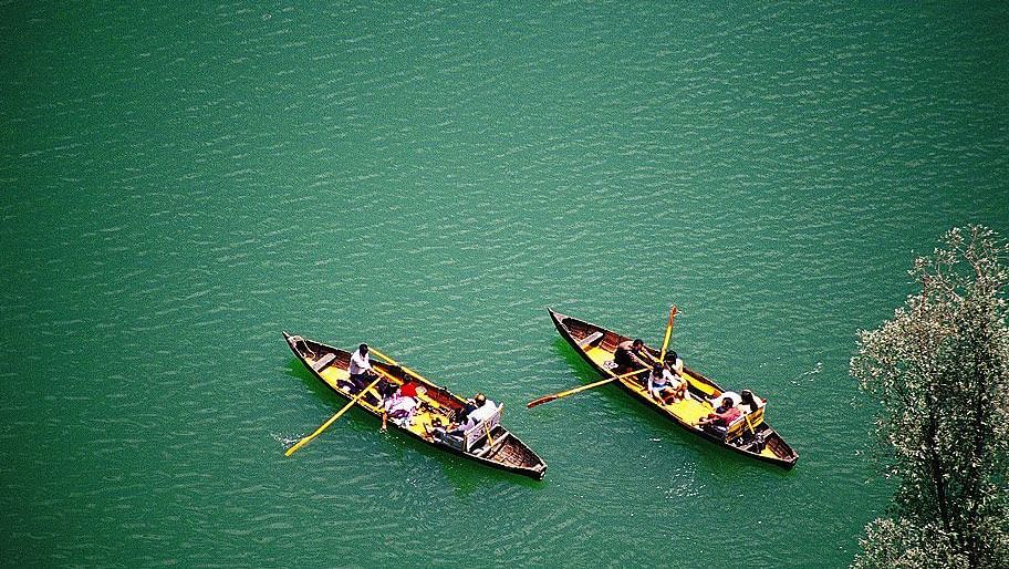 An image of two boats floating on a lake