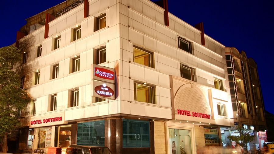 Facade of Hotel Southern building illuminated at night, featuring a modern facade with visible signage and surrounding city lights in Karol Bagh, New Delhi