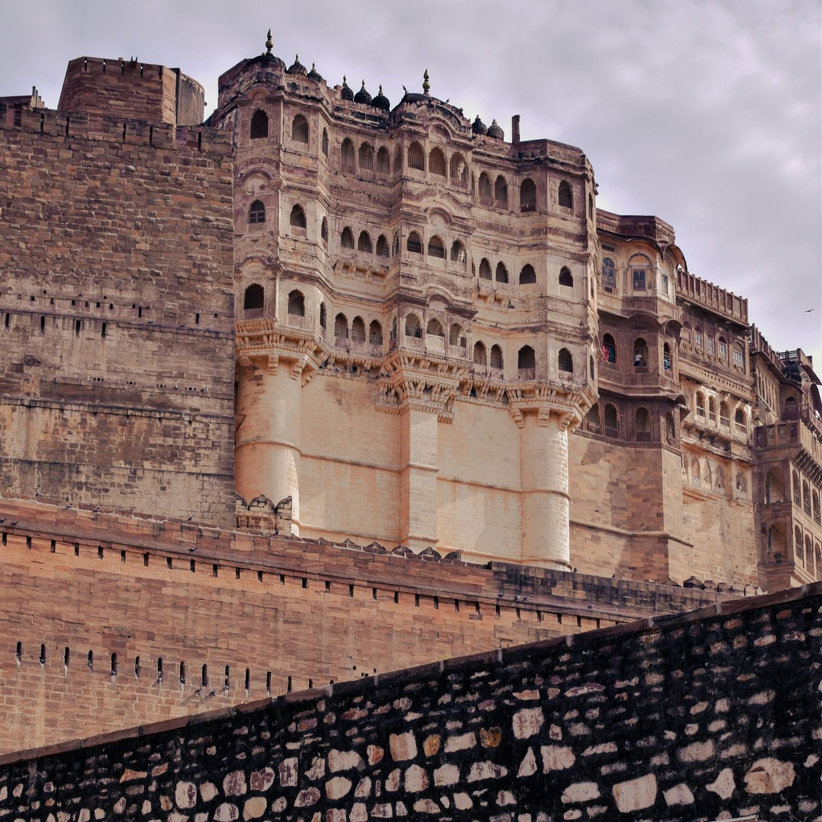 Majestic Mehrangarh Fort towering over Jodhpur, showcasing its massive stone walls and historic architecture against the sky.