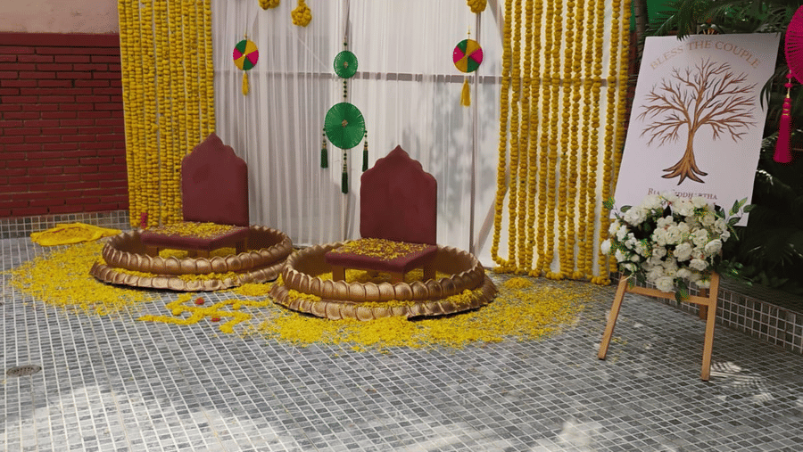 Elegantly decorated wedding mandap at The Piccadily with floral arrangements, yellow drapes, and traditional ceremonial decor on a patterned outdoor floor.