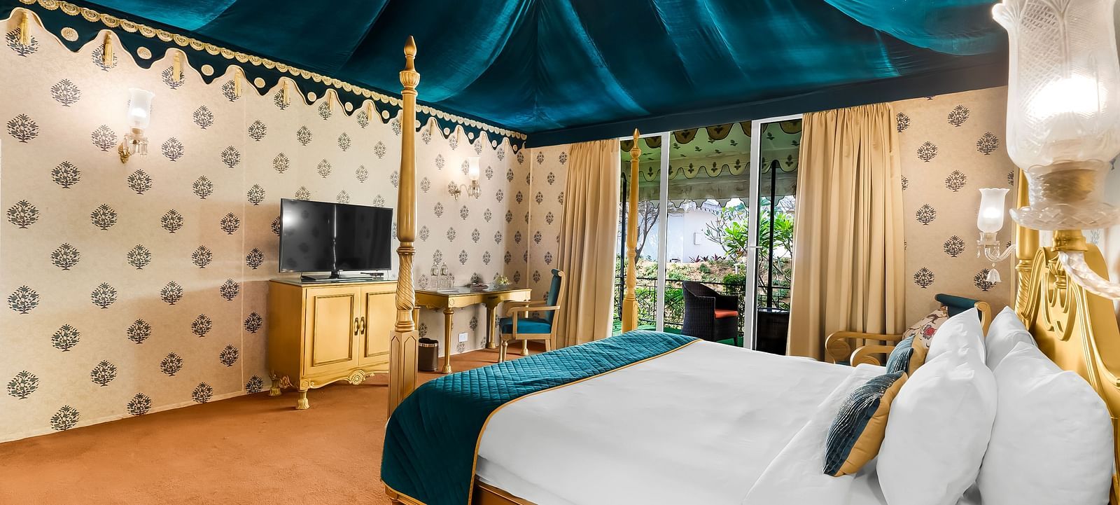 An overview of a tent with a double bed and a tv in front of it - Rajasthali Resort & Spa, Jaipur.