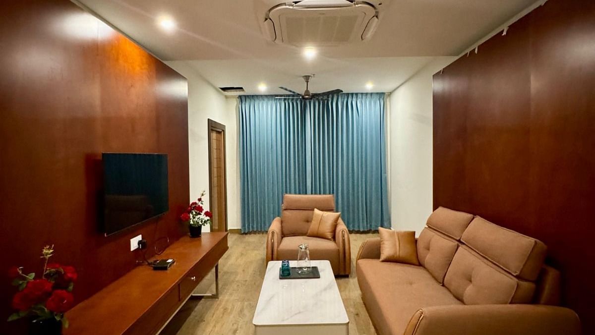 Image of Majestic Suite seating area with sofas and a television in front of it  at Le Royale Palace.