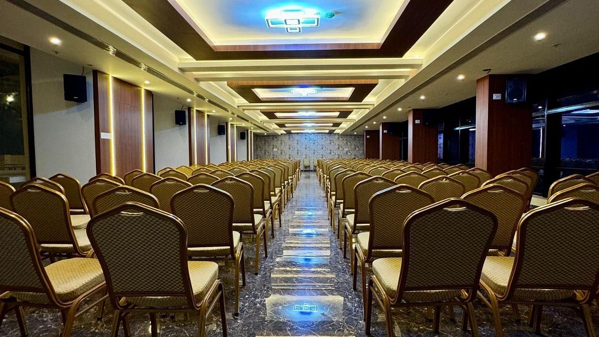 Image of a banquet hall with chairs and lights on the ceiling at Le Royale Palace.
