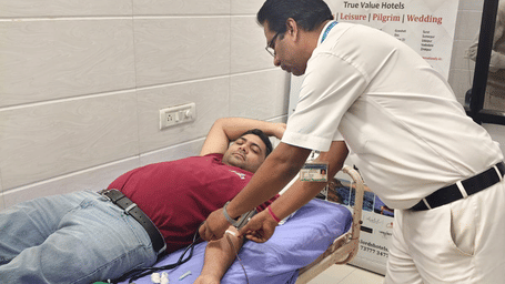 Staff assisting a guest with wellness therapy treatment at Lords Hotels and Resorts.