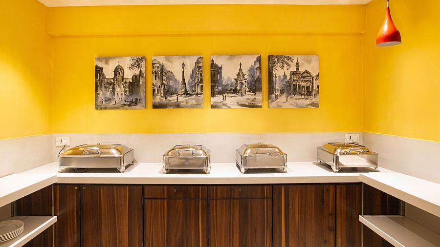 A wide angle image if the food counter with the paintings 