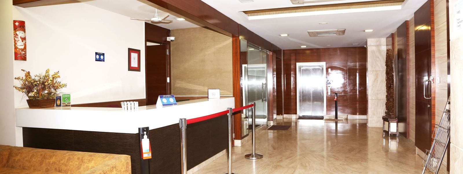 Reception area with front desk and wooden wall panels at Fressotel Seetharam, Coimbatore