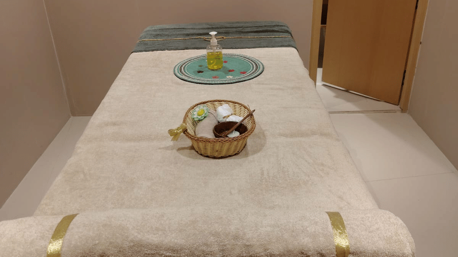 Therapy room at ABN Sarovar Portico, Jim Corbett featuring a spa bed, towels, and spa products kept on the bed.