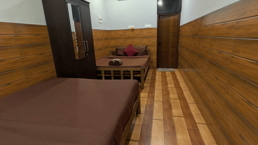 Cosy wooden interior with bench seating at Holistic Eco-Resort, Kannur.