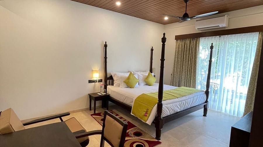 bedroom with bed, table and chairs - Mastiff Grand La Villae Resort, Lonavala