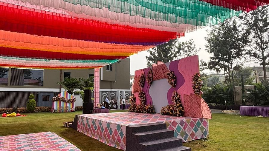 An image of a lawn decorated with  colourful fabrics, flowers, designed carpets, chairs,and other decorative items to organise an event - VRR Astoria Hotel and Convention Centre