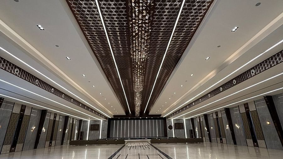 Elegant hall with intricate ceiling design and marble flooring