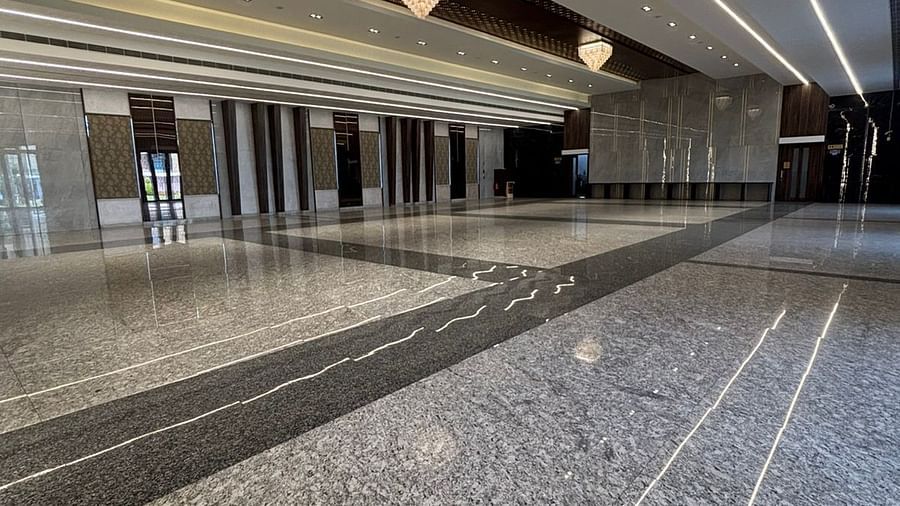 Elegant hall with intricate ceiling design and marble flooring