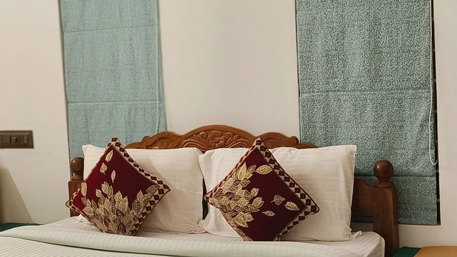A zoomed in view of a double bed in the 104 room at Ananda Holiday Home, Wayanad 2