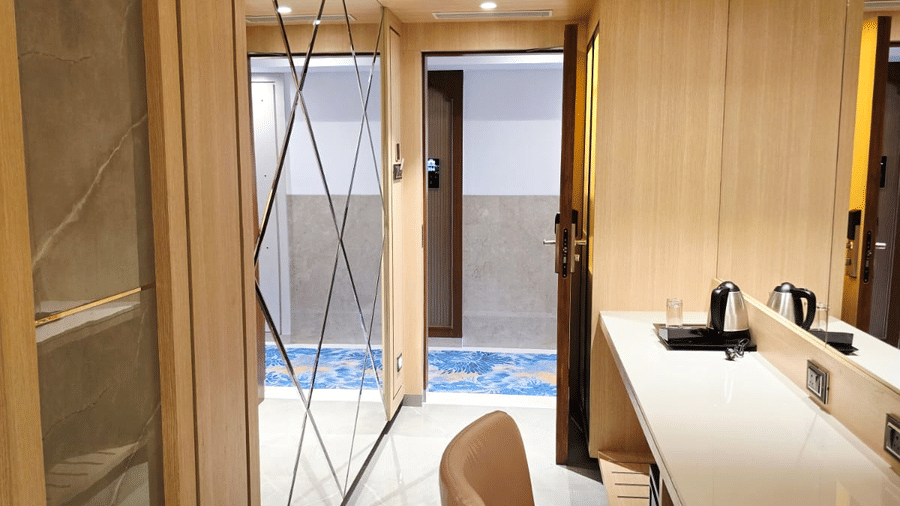 Contemporary room with wardrobe, desk, and mirror at Hotel Mumbai House, Digha, Airoli.