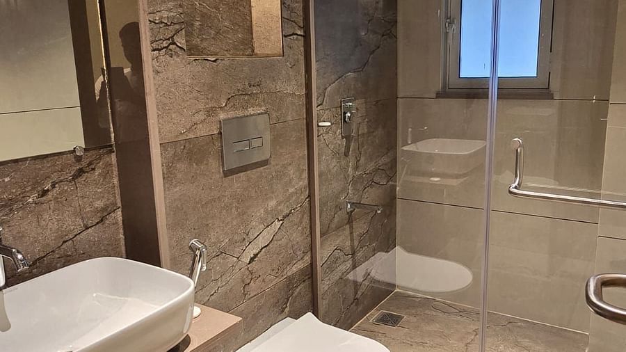 Bathroom featuring a wash basin and shower space at Hotel Mumbai House, Vashi.