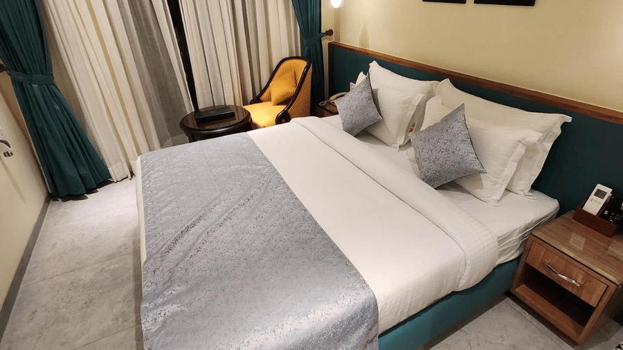 Well-appointed Super Deluxe Room with a comfortable bed, modern furnishings and warm interiors at Hotel Southgate Goa, Calangute, ideal for a relaxing stay.