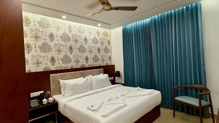 Image of a room with bed, chair and a fan on the ceiling at Le Royale Palace.