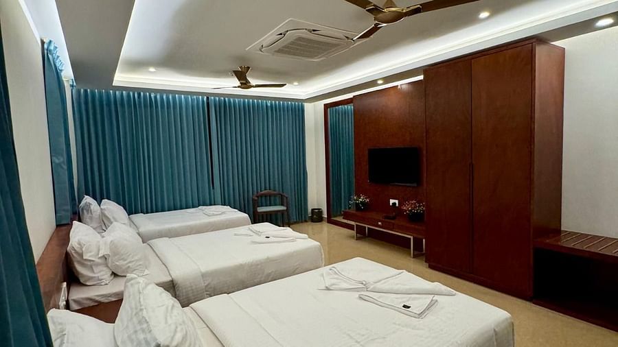 Side view of Deluxe Quadruple with four beds and wardrobes in front of the beds at Le Royale Palace.