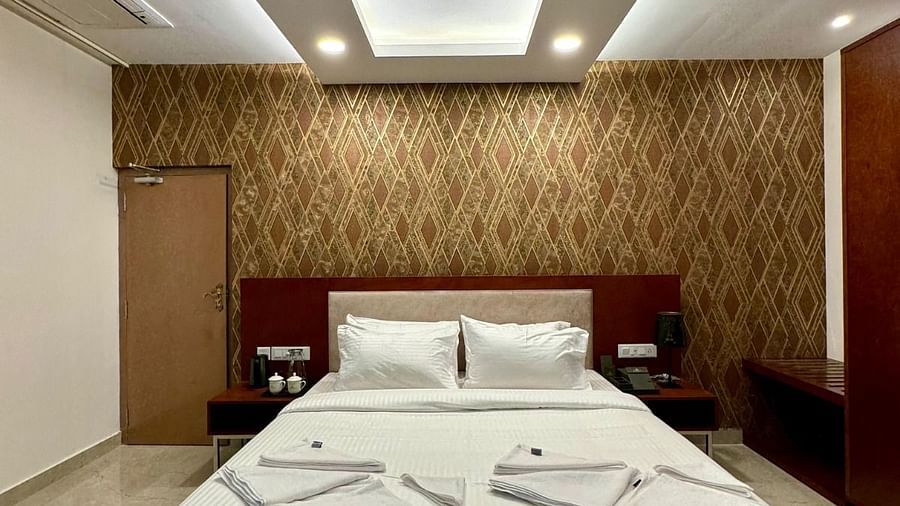 image of Execuitive King Room with a bed and a fan on the the ceiling at Le Royale Palace.
