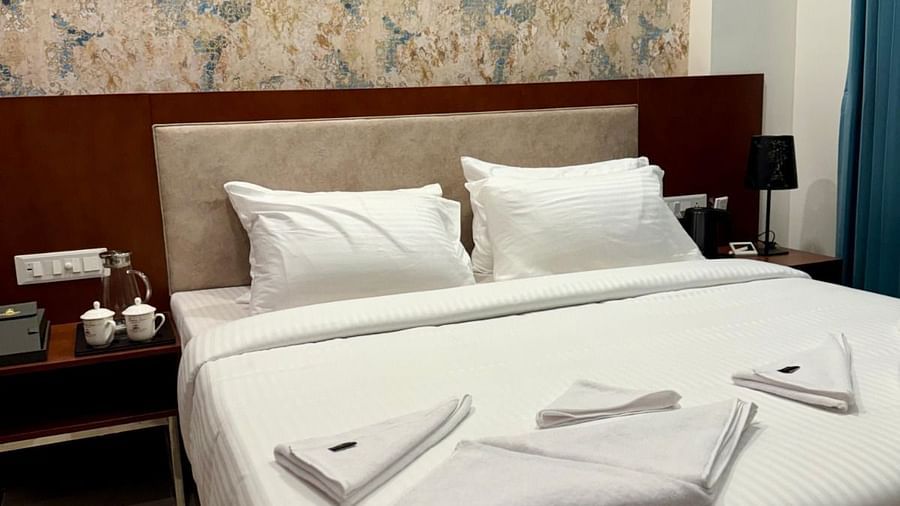 Image of family suite with a bed with bedside tables on either sides of the bed  at Le Royale Palace.