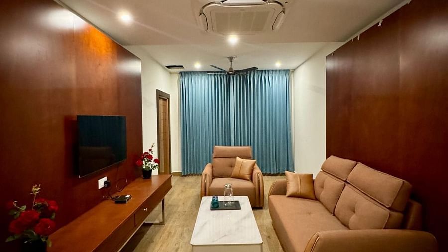 Image of Majestic Suite seating area with sofas and a television in front of it  at Le Royale Palace.