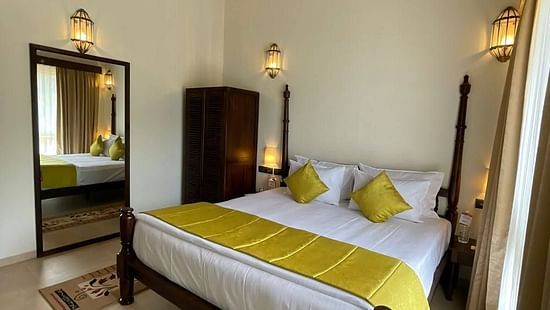 bedroom interior with bed, ceiling fan and wardrobe - Mastiff Grand La Villae Resort, Lonavala