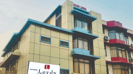 The exterior facade of Pemaling Lords Eco Inn Guwahati featuring the property signage and modern architectural design.