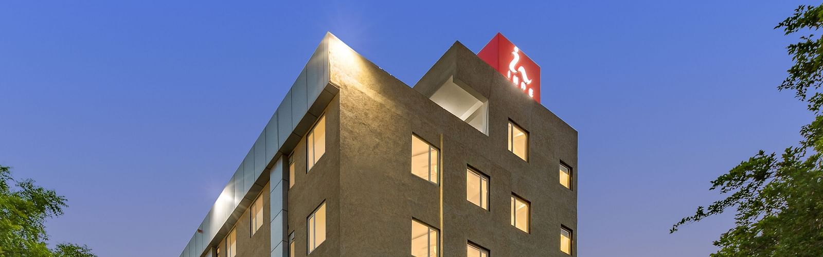 Facade image of  Inde Hotel Cyber City with backdrop of blue sky