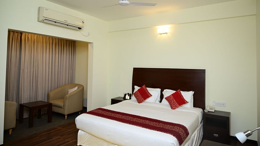 A double bed with red blanket and red pillow covers in the Executive Suite at Sterling Keys by TGI 1