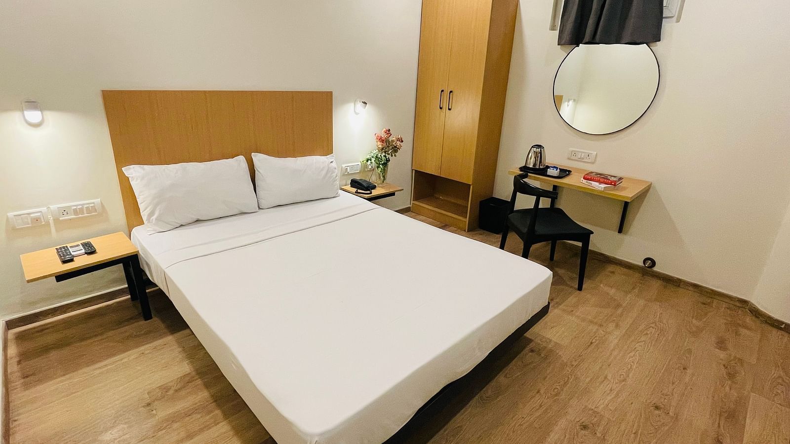 A double bed and a work desk at Sanctum Suites Richmond Road, Bangalore