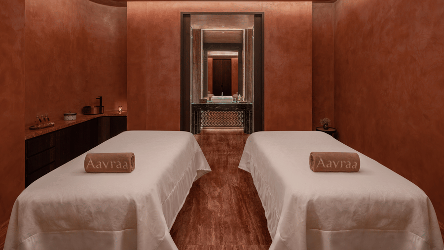 Spa treatment room with two massage beds set against warm toned walls at The Residency Signature Madurai.