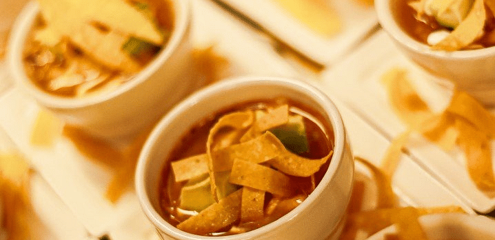 An image of appetizers or small dishes, including dips, vegetables, and other snacks.