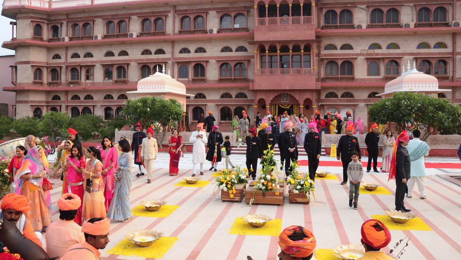 Grand wedding ceremony in a palace courtyard with traditional decor.