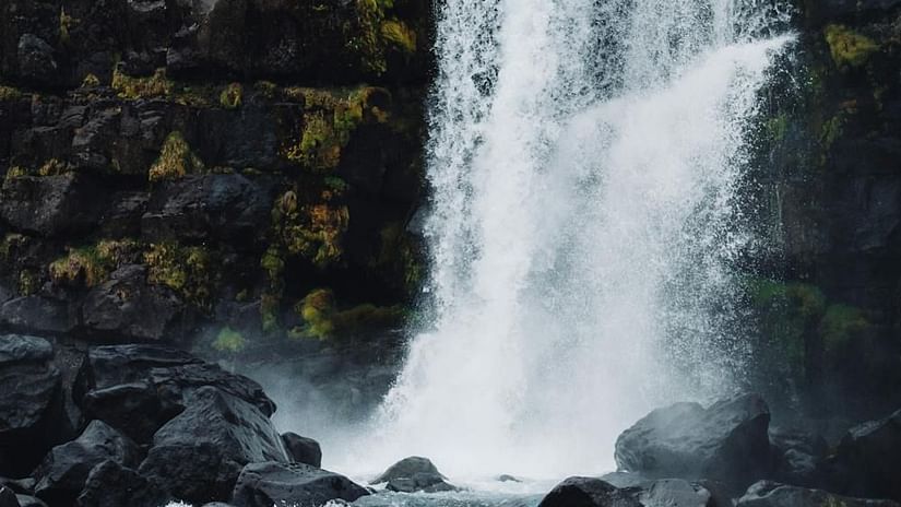 Image of a waterfall cascading through rocks with a glommy sky in the background - The Dukes Retreat, Khandala