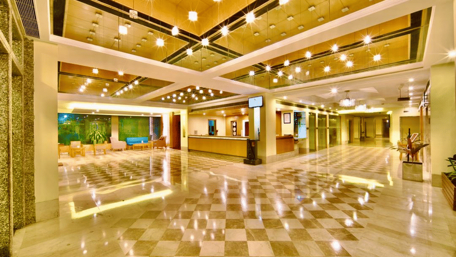 A spacious, brilliantly lit lobby with modern design elements in Lords Plaza Ankleshwar