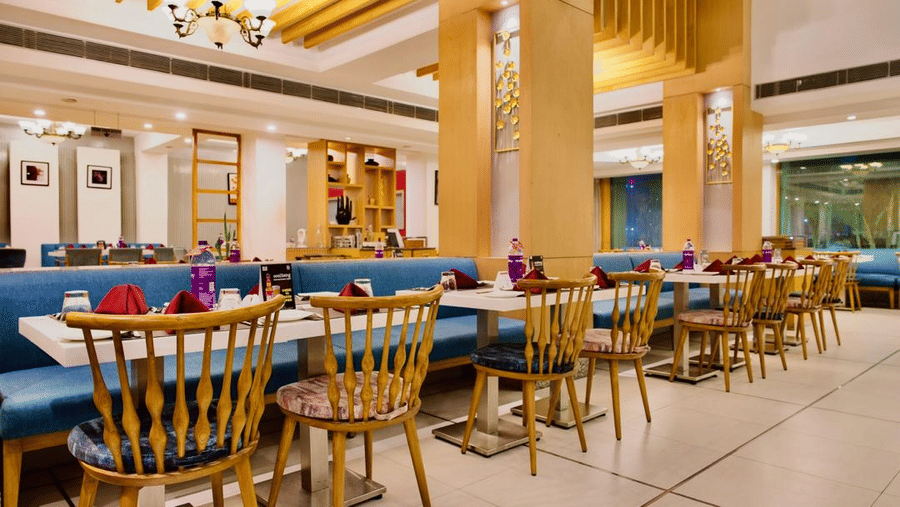 Dining area of Lords Plaza Ankleshwar featuring comfortable seating and modern interiors
